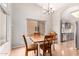 Charming dining area with a rustic table and chairs, adjacent to the kitchen at 19522 N 84Th Ave, Peoria, AZ 85382