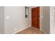 Bright and airy entryway with a rich wood door and tiled floor at 19522 N 84Th Ave, Peoria, AZ 85382