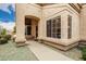 Inviting walkway leading to the home's front entrance with large windows at 19522 N 84Th Ave, Peoria, AZ 85382