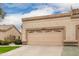 Attached garage with a double-door, providing ample parking and storage at 19522 N 84Th Ave, Peoria, AZ 85382