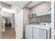 Laundry room with washer, dryer, and shelving at 19522 N 84Th Ave, Peoria, AZ 85382
