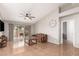Spacious living room featuring a cozy sofa, large windows, and tile floors at 19522 N 84Th Ave, Peoria, AZ 85382