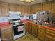 View of kitchen stove, double sink, and wood cabinets at 20021 N 18Th Ave, Phoenix, AZ 85027