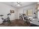 Bright home office features a desk, chair, shelving, and exercise bike at 20619 N 16Th Way, Phoenix, AZ 85024