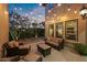 Evening view of the backyard patio with string lights creating a warm ambiance at 21415 N 37Th Run, Phoenix, AZ 85050