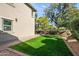 Landscaped side yard with grassy area and brick path at 21415 N 37Th Run, Phoenix, AZ 85050