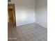 Simple living room with tile flooring and ample space at 2150 W Missouri Ave # 121, Phoenix, AZ 85015