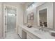 Double vanity bathroom with large mirrors and a walk-in shower at 22926 N De La Guerra Ct, Sun City West, AZ 85375