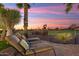 Spacious patio with lounge chairs and breathtaking sunset views at 22926 N De La Guerra Ct, Sun City West, AZ 85375