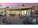 Extended patio with seating, dining area and views into the home at 22926 N De La Guerra Ct, Sun City West, AZ 85375