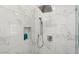 Walk-in shower with rainfall shower head and marble tile at 22926 N De La Guerra Ct, Sun City West, AZ 85375