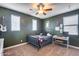 Green-walled bedroom with a bed, desk, and window at 26741 N 74Th Ave, Peoria, AZ 85383