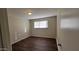 Simple bedroom with hardwood floors and window at 3614 W Elm St, Phoenix, AZ 85019