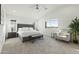 Bright main bedroom with plush carpeting and a large window at 470 S Soho Ln # 1, Chandler, AZ 85225