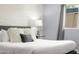 King-size bed in a well-lit bedroom with textured wall at 6834 E 4Th St # 7, Scottsdale, AZ 85251