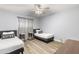 Twin bedroom with two beds, desks, and ceiling fan at 6834 E 4Th St # 7, Scottsdale, AZ 85251