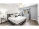Spacious bedroom with a king-size bed, wave patterned wall, and ceiling fan at 6834 E 4Th St # 7, Scottsdale, AZ 85251