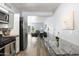 Modern kitchen with stainless steel appliances and glass dining table at 6834 E 4Th St # 7, Scottsdale, AZ 85251