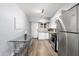 Modern kitchen with stainless steel appliances and glass dining table at 6834 E 4Th St # 7, Scottsdale, AZ 85251