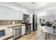 Modern kitchen with stainless steel appliances, concrete countertops, and glass-top dining table at 6834 E 4Th St # 7, Scottsdale, AZ 85251