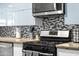 Close-up of kitchen stovetop and stylish backsplash at 6834 E 4Th St # 7, Scottsdale, AZ 85251