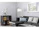 Living room with black leather couch and floor lamp at 6834 E 4Th St # 7, Scottsdale, AZ 85251