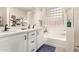 Spa-like bathroom with double sinks, large tub, and block window at 7093 W Andrew Ln, Peoria, AZ 85383