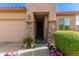 Front entrance with stone pillars, a dark door, and potted plants at 7093 W Andrew Ln, Peoria, AZ 85383