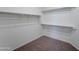 Large walk-in closet with double hanging rods and carpet flooring at 7420 S 34Th Ln, Phoenix, AZ 85041