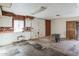 A fixer-upper kitchen with brick walls and wood paneling at 7519 W Wolf St, Phoenix, AZ 85033