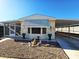 Inviting single-wide manufactured home with carport and landscaped front yard at 9302 E Broadway Rd # 184, Mesa, AZ 85208