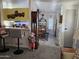 Open kitchen and dining area with breakfast bar and wood table at 9302 E Broadway Rd # 184, Mesa, AZ 85208