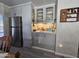 Convenient wet bar with gray cabinets and glass-front doors at 9302 E Broadway Rd # 184, Mesa, AZ 85208