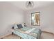 Well-lit bedroom with patterned bedding and window at 1060 S Kellis Rd, Wickenburg, AZ 85390