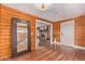 Entryway with wood floors and a view into the living room with fireplace at 1060 S Kellis Rd, Wickenburg, AZ 85390