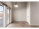 Cozy dining area with tile floors and sliding glass door access to patio at 12322 W Larkspur Rd, El Mirage, AZ 85335