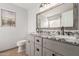 Bathroom with granite countertops and double sinks at 12479 W Palm Ln, Avondale, AZ 85392