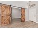 Entryway with rustic barn doors and light wood flooring at 12479 W Palm Ln, Avondale, AZ 85392