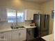 Updated kitchen with white cabinets and quartz countertops at 1409 E Apollo Rd, Phoenix, AZ 85042