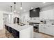 Modern kitchen with white cabinets, large island with seating, and stainless steel appliances at 20606 W Lost Creek Dr, Buckeye, AZ 85396