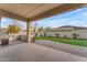 Covered patio with a built-in grill and artificial turf at 21559 E Russet Rd, Queen Creek, AZ 85142