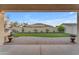 Landscaped backyard with artificial turf and covered patio at 21559 E Russet Rd, Queen Creek, AZ 85142
