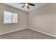 Simple bedroom with ceiling fan and window at 21559 E Russet Rd, Queen Creek, AZ 85142