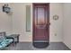 Inviting entryway with a dark-colored door and a small bench at 21559 E Russet Rd, Queen Creek, AZ 85142