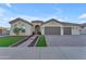 Beautiful single-story home with a three-car garage and landscaped front yard at 21559 E Russet Rd, Queen Creek, AZ 85142