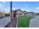 Landscaped front yard with artificial turf and a walkway at 21559 E Russet Rd, Queen Creek, AZ 85142