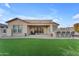 House exterior showcasing backyard patio and landscaping at 21559 E Russet Rd, Queen Creek, AZ 85142