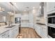 White kitchen cabinets, granite countertops, and stainless steel appliances at 21559 E Russet Rd, Queen Creek, AZ 85142