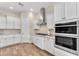 Modern kitchen with stainless steel appliances and white cabinets at 21559 E Russet Rd, Queen Creek, AZ 85142