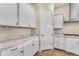 White kitchen cabinets and granite countertops with pantry at 21559 E Russet Rd, Queen Creek, AZ 85142